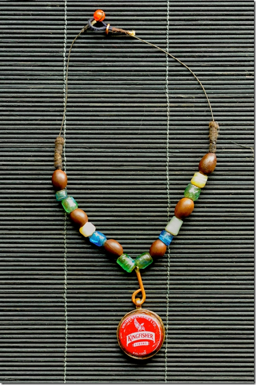 Amman Rashid necklace (2011) Kingfisher beer bottle cap, lotus seed beads, glass beads, copper wire, cotton thread and carnelian agate, approx 14 inches, photo: Anil Advani